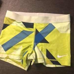 Unique neon green geometric shape Nike pros.